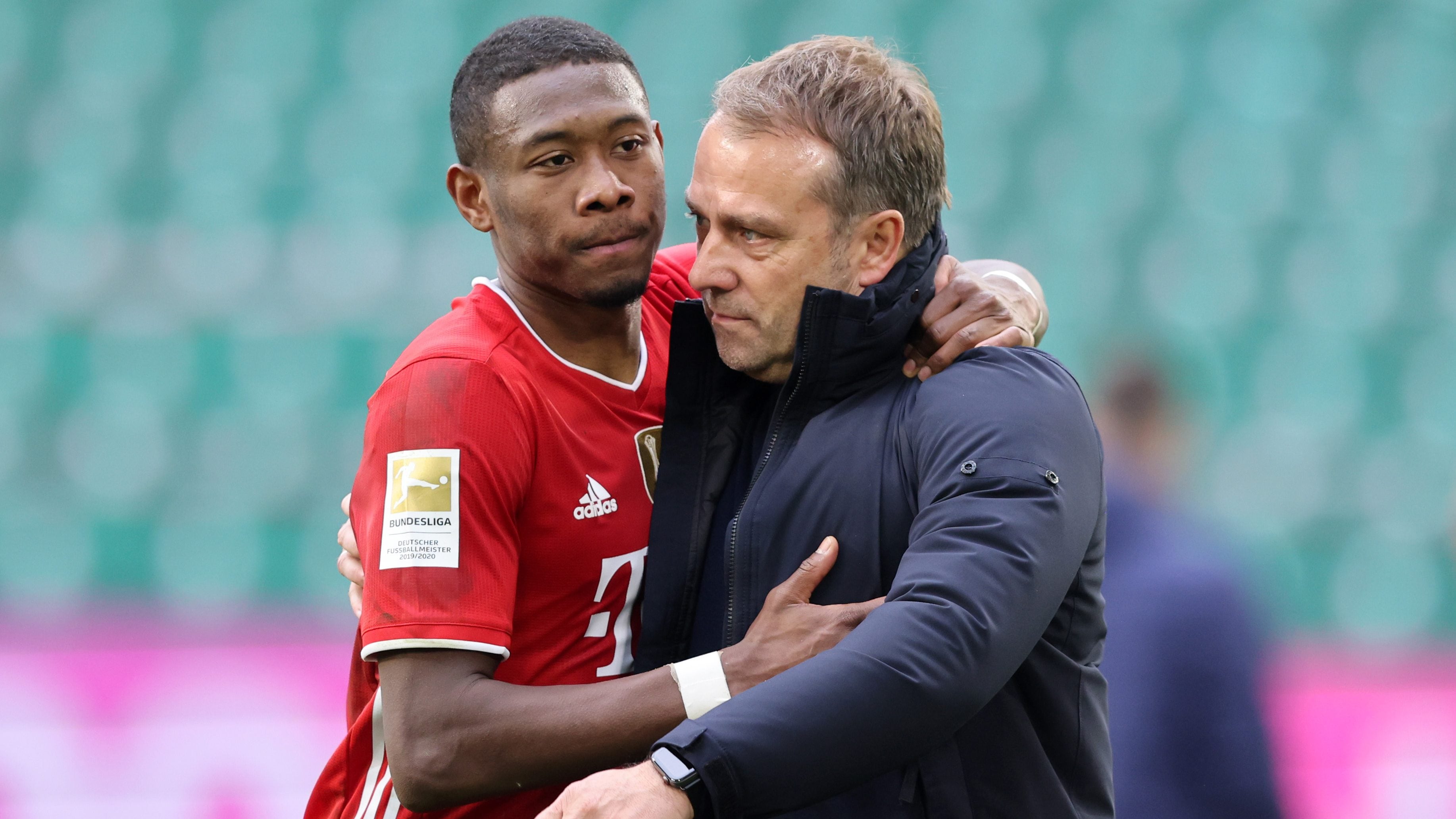 WOLFSBURG, GERMANY - APRIL 17: David Alaba and Coach Hansi Hans Flick of Bayern Muenchen hug after the Bundesliga match between VfL Wolfsburg and FC Bayern Muenchen at Volkswagen Arena on April 17, 2021 in Wolfsburg, Germany. Sporting stadiums around Germany remain under strict restrictions due to the Coronavirus Pandemic as Government social distancing laws prohibit fans inside venues resulting in games being played behind closed doors. (Photo by Stefan Matzke - sampics/Corbis via Getty Images)