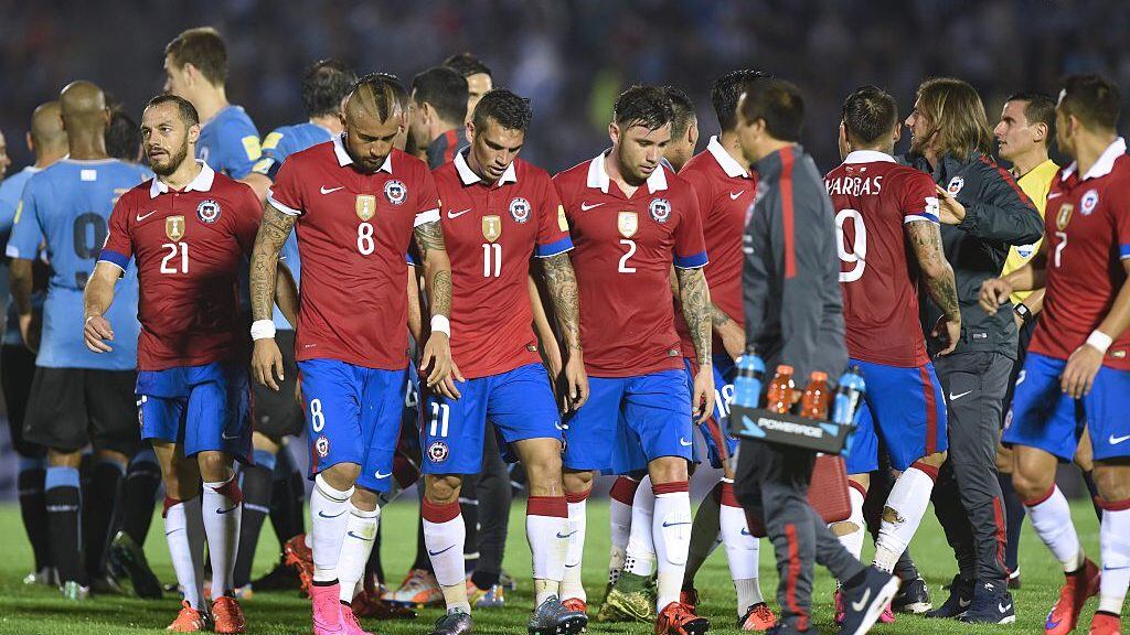 Chilean players leave the field after the end of their Russia 2018 FIFA World Cup South American Qualifiers football match against Uruguay, in Montevideo, on November 17, 2015. AFP PHOTO / PABLO PORCIUNCULA        (Photo credit should read PABLO PORCIUNCULA/AFP via Getty Images)