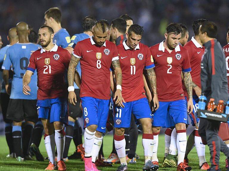 Chilean players leave the field after the end of their Russia 2018 FIFA World Cup South American Qualifiers football match against Uruguay, in Montevideo, on November 17, 2015. AFP PHOTO / PABLO PORCIUNCULA (Photo credit should read PABLO PORCIUNCULA/AFP via Getty Images)