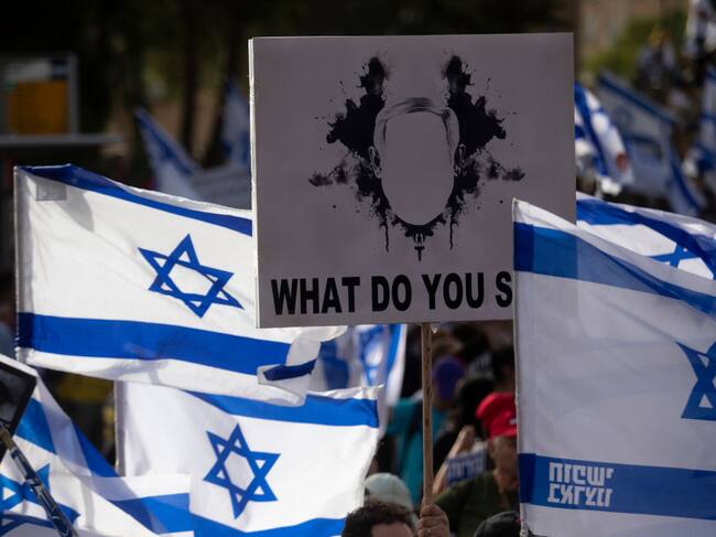JERUSALEM - MAY 20: Protesters hold signs and flags during a demonstration calling for a hostages deal and against Israeli Prime Minister Benjamin Netanyahu and the government on May 20, 2024 in Jerusalem. As Israel's government reconvenes after a month-long recess, anti-government protesters and supporters of those kidnapped by Hamas on October 7 2023, continue demonstrating on the streets of Jerusalem. (Photo by Amir Levy/Getty Images)