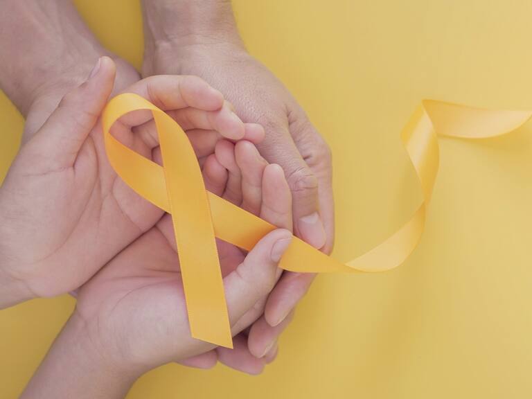 adult and child hands holding yellow gold ribbon, Sarcoma Awareness, Bone cancer, childhood cancer awareness, world suicide prevention day, September Yellow