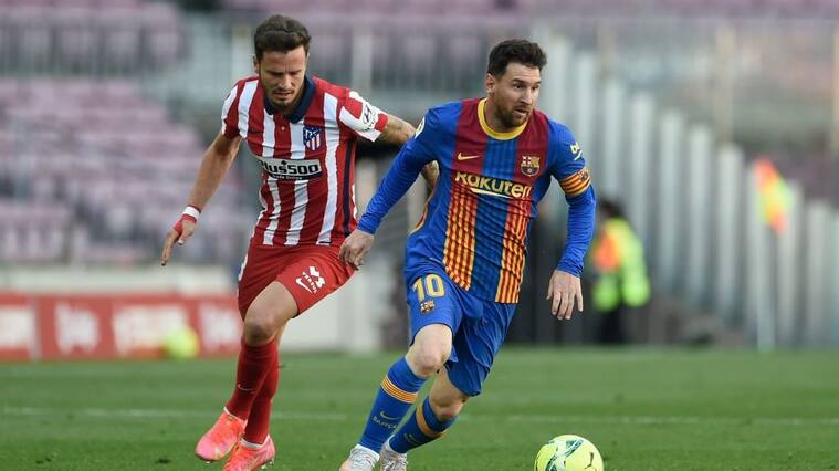 Atletico Madrid's Spanish midfielder Saul Niguez (L) challenges Barcelona's Argentinian forward Lionel Messi during the Spanish league football match FC Barcelona against Club Atletico de Madrid at the Camp Nou stadium in Barcelona on May 8, 2021. (Photo by Josep LAGO / AFP) (Photo by JOSEP LAGO/AFP via Getty Images)