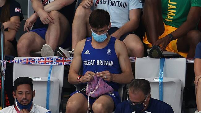 TOKYO, JAPAN - AUGUST 01: Tom Daley of Great Britain knits as he watches the Women's 3m Springboard Final on day nine of the Tokyo 2020 Olympic Games at Tokyo Aquatics Centre on August 01, 2021 in Tokyo, Japan. (Photo by Clive Rose/Getty Images)