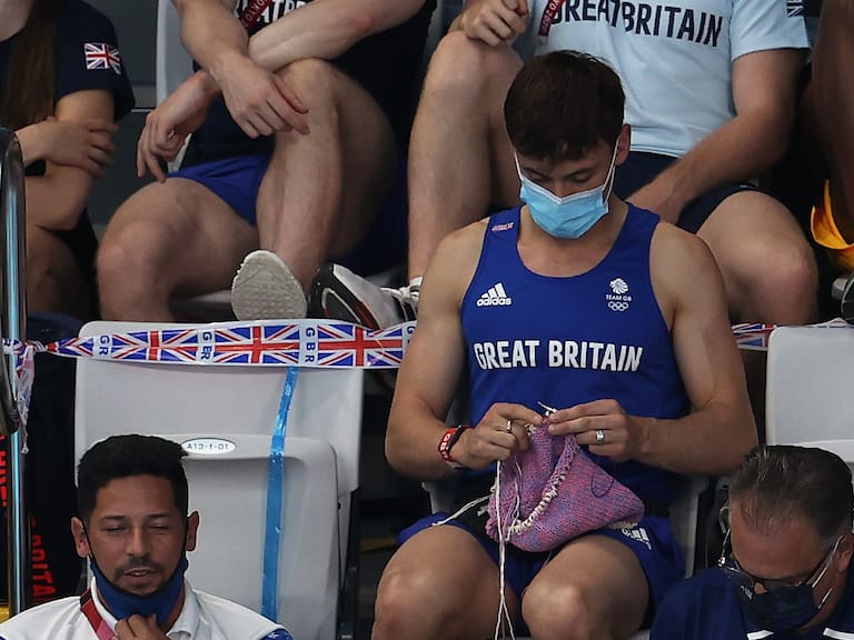 TOKYO, JAPAN - AUGUST 01: Tom Daley of Great Britain knits as he watches the Women's 3m Springboard Final on day nine of the Tokyo 2020 Olympic Games at Tokyo Aquatics Centre on August 01, 2021 in Tokyo, Japan. (Photo by Clive Rose/Getty Images)