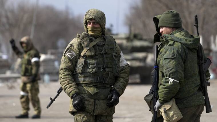 MARIUPOL, UKRAINE - MARCH 20: Security forces are seen as civilians trapped in Mariupol city under Russian attacks, are evacuated in groups under the control of pro-Russian separatists, through other cities, in Mariupol, Ukraine on March 20, 2022. (Photo by Stringer/Anadolu Agency via Getty Images)