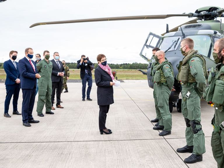 25 September 2020, Lower Saxony, Faßberg: Annegret Kramp-Karrenbauer (CDU, M), Minister of Defence, is having the technology of the transport helicopter &quot;NH90&quot; explained to her during her visit to the Faßberg airbase in the administrative district of Celle. Among other things, the visit is about the upcoming Afghanistan mission of the army planes. Photo: Moritz Frankenberg/dpa (Photo by Moritz Frankenberg/picture alliance via Getty Images)