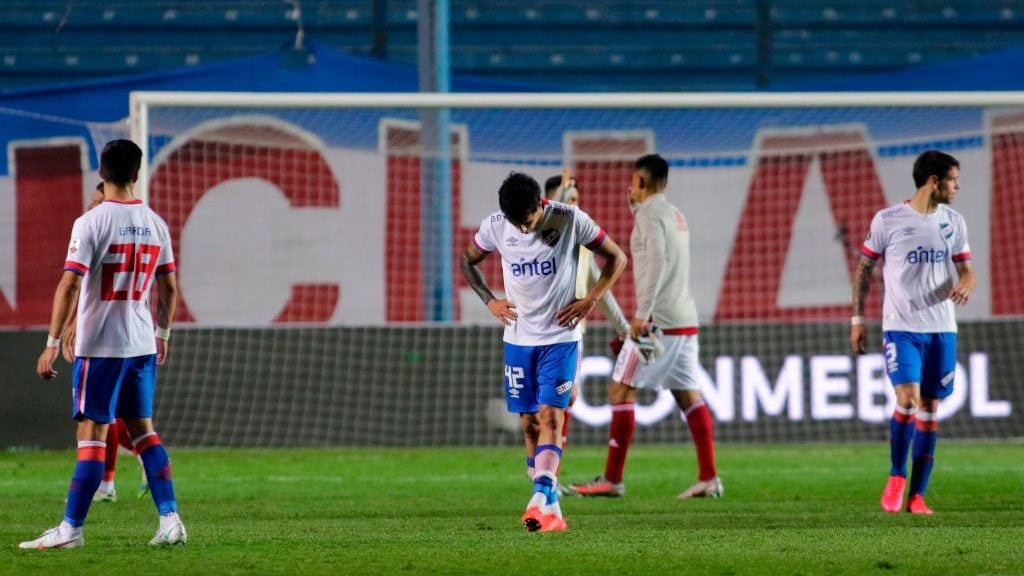Uruguay's Nacional Pablo Garcia (L), Ignacio Lores (C) and Renzo Orihuela leave the field in defection after losing 6-2 to Argentina's River Plate in a closed-door Copa Libertadores quarterfinal football match at the Gran Parque Central stadium in Montevideo on December 17, 2020. (Photo by Ernesto RYAN / POOL / AFP) (Photo by ERNESTO RYAN/POOL/AFP via Getty Images)