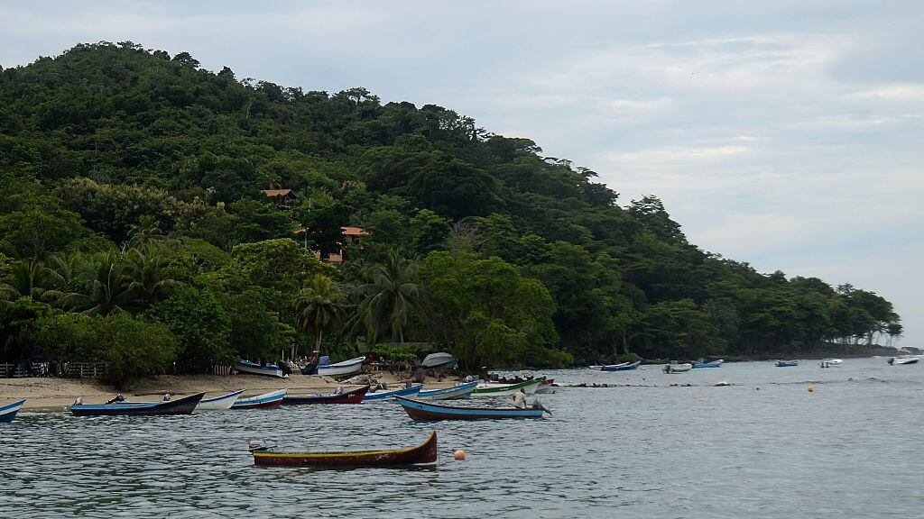 Picture taken in Capurgana, in the Caribbean Gulf of Uraba in northwestern Colombia, where Cuban, Haitian and other migrants arrive to make their way through the jungle to illegally get to Panama, on August 4, 2016. Hundreds of Cubans, Haitians and other migrants are stranded in Colombia since mid-May after Central American countries tightened their border controls. Following a massive US-bound influx of migrants, Colombia has adopted emergency measures against illegal migration, which include plans to deport thousands of migrants as well as reinforcing its borders.
 / AFP / RAUL ARBOLEDA        (Photo credit should read RAUL ARBOLEDA/AFP via Getty Images)