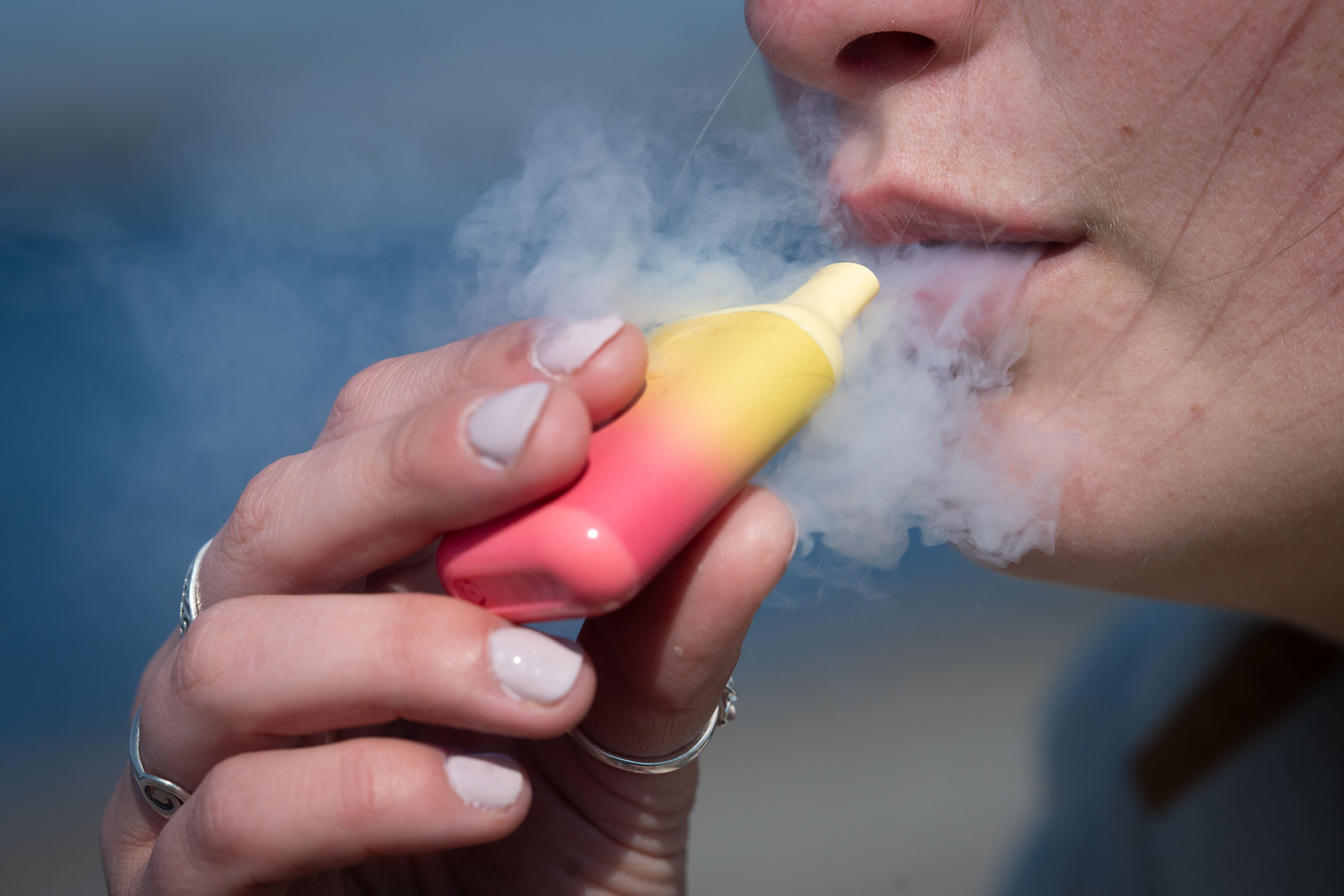 CARDIFF, WALES - APRIL 5: A woman poses for a photograph holding a single-use vape on April 5, 2025 in Cardiff, United Kingdom. The UK will ban the sale and supply of single-use vapes from June 1st, 2025, aiming to tackle litter and plastic pollution. Anyone flouting the ban will face a £200 fine. (Photo by Matthew Horwood/Getty Images)