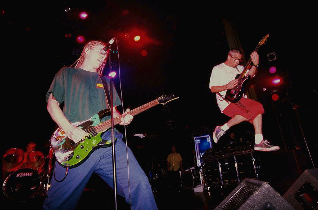 Singer/guitarists  Dexter Holland (left) and Noodles (Kevin Wasserman) performing with American punk group The Offspring, London 1995. (Photo by Mick Hutson/Redferns/Getty Images)