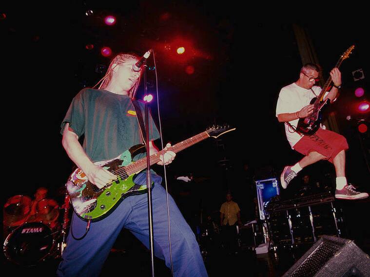 Singer/guitarists Dexter Holland (left) and Noodles (Kevin Wasserman) performing with American punk group The Offspring, London 1995. (Photo by Mick Hutson/Redferns/Getty Images)