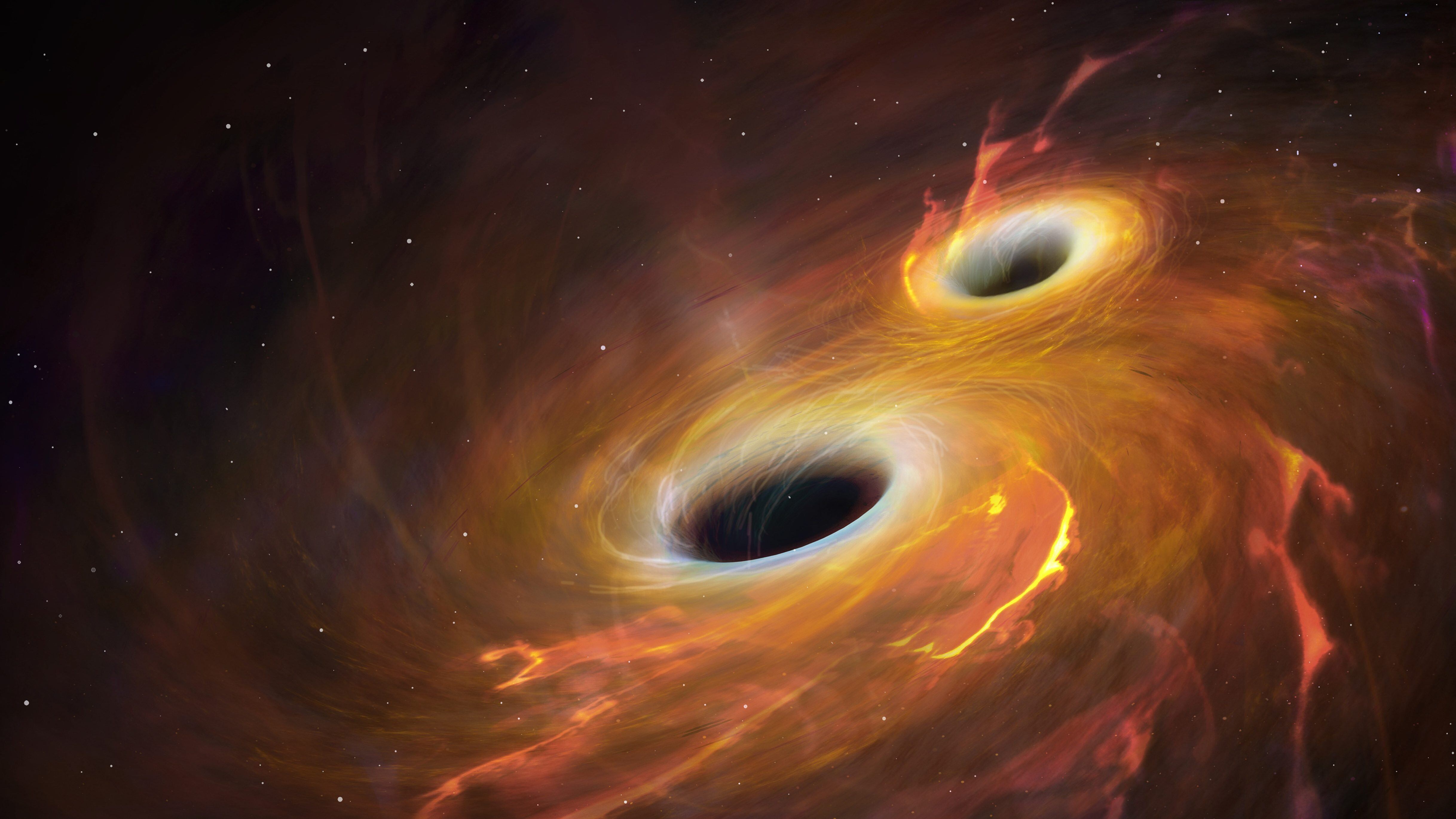 Illustration of two black holes orbiting each other in a combined accretion disc. Eventually the black holes will merge, an event that will produce gravitational waves. Gravity is the distortion of space-time by mass, and changes in this distortion travel in waves at the speed of light. The effect is most pronounced where extremely massive objects are subject to extremely high acceleration. This is seen, for instance, where black holes or neutron stars are in a close orbit such as this. In February 2016, gravitational waves were detected for the first time, 100 years after Einsteins prediction. The waves emanated from the collision of two black holes, of 36 and 29 solar masses, some 1.3 billion light years away. The waves were extremely faint by the time they arrived at Earth, where they were detected by the two LIGO detectors in the USA.