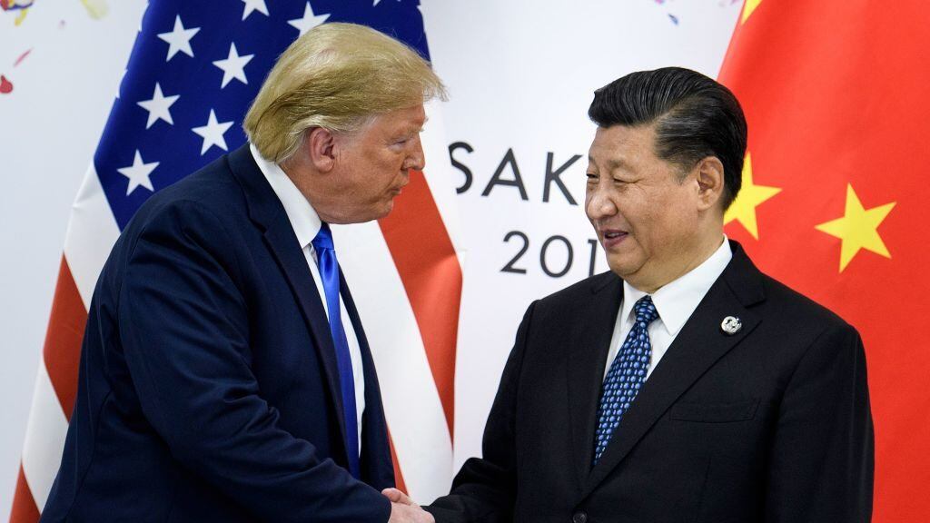 (FILES) In this file photo taken on June 28, 2019, China's President Xi Jinping (R) shakes hands with US President Donald Trump before a bilateral meeting on the sidelines of the G20 Summit in Osaka. - From the Arab Spring to bloodletting in Syria, from Obama to Trump, from terror in the streets of Paris to Brexit, the 2010s began with hope for a more equitable world, and end with a slide towards nationalistic populism. (Photo by Brendan Smialowski / AFP) (Photo by BRENDAN SMIALOWSKI/AFP via Getty Images)