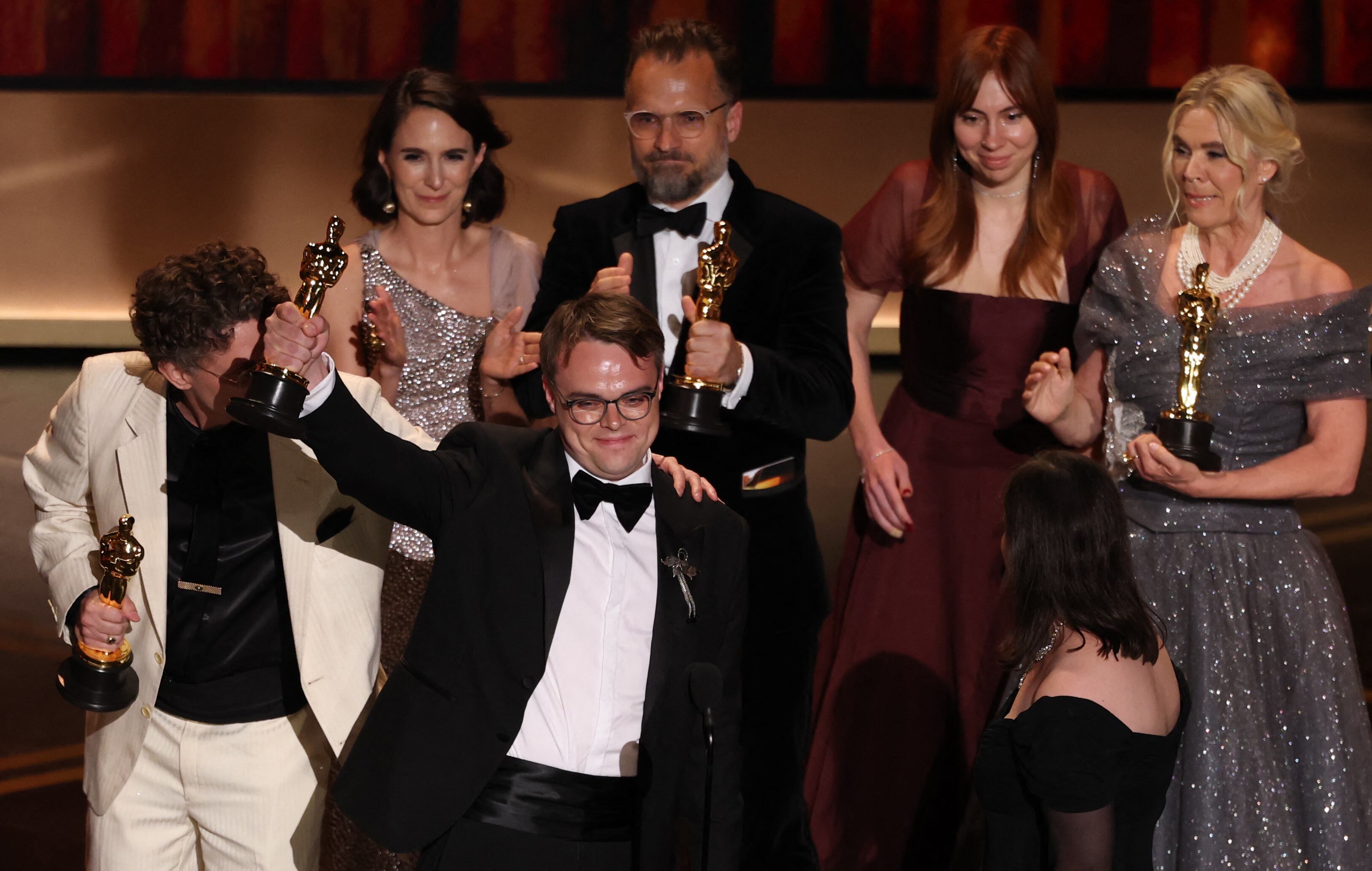 Russian teacher Pavel Talankin (2L) stands alongside US documentary filmmaker David Borenstein (L) as he accepts the award for Best Documentary Feature Film for "Mr. Nobody Against Putin" onstage during the 98th Annual Academy Awards at the Dolby Theatre in Hollywood, California. (Photo by Patrick T. Fallon / AFP via Getty Images)