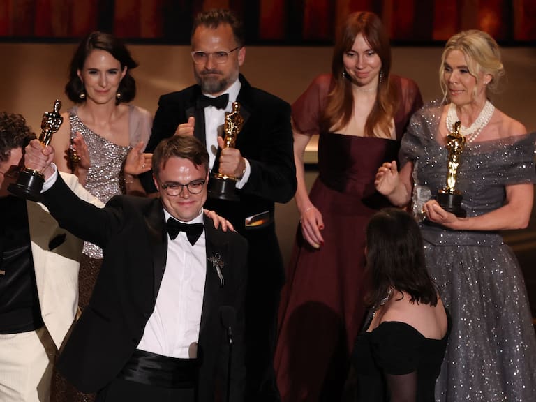 Russian teacher Pavel Talankin (2L) stands alongside US documentary filmmaker David Borenstein (L) as he accepts the award for Best Documentary Feature Film for "Mr. Nobody Against Putin" onstage during the 98th Annual Academy Awards at the Dolby Theatre in Hollywood, California. (Photo by Patrick T. Fallon / AFP via Getty Images)