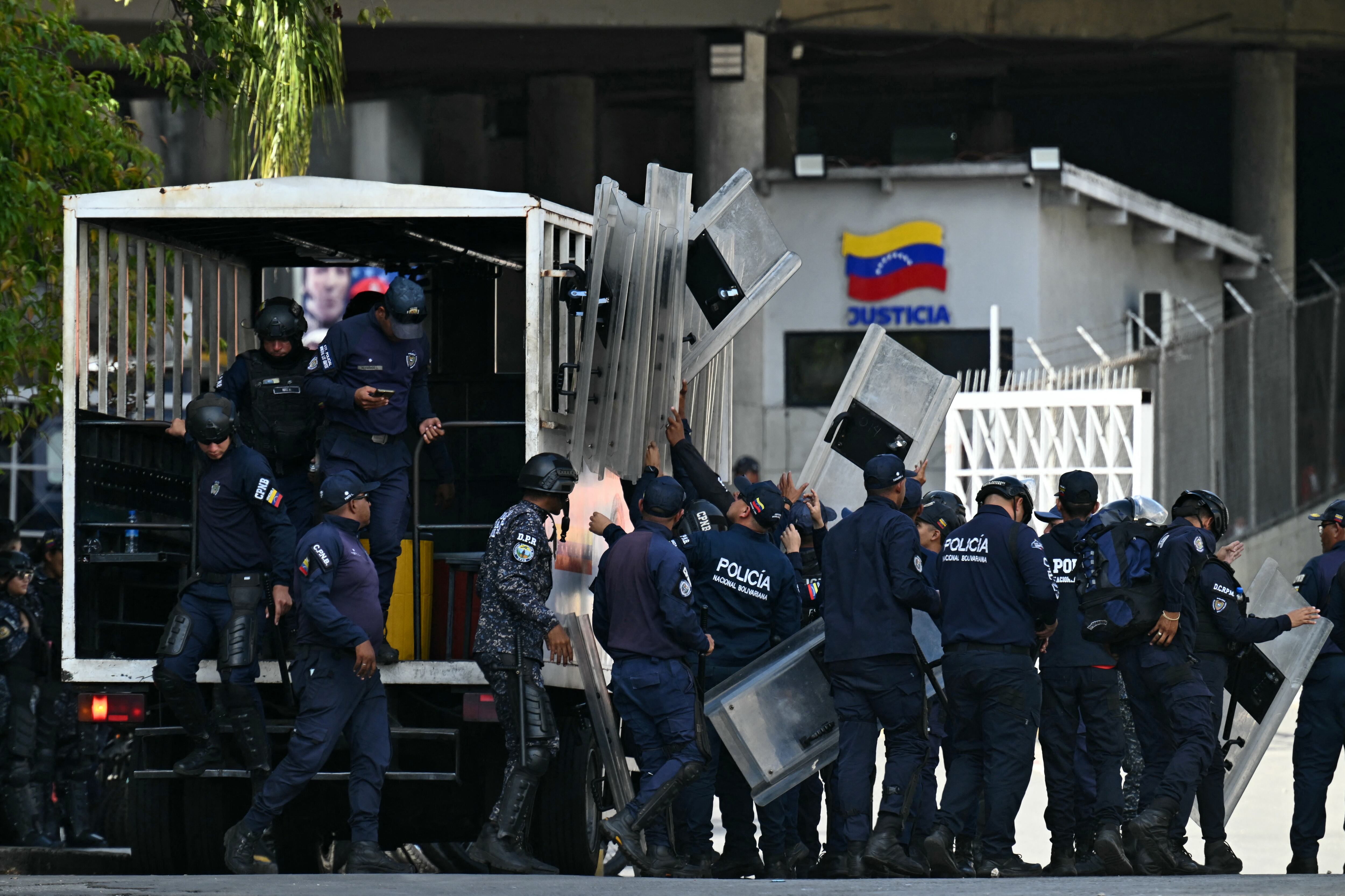 Security forces arrive at the El Helicoide -a facility and prison owned by the Venezuelan government and used for both regular and political prisoners of the Bolivarian National Intelligence Service (SEBIN)- in Caracas on January 8, 2026. Venezuelan authorities are releasing a "large number" of prisoners, some of them foreigners, five days after US forces ousted authoritarian leader Nicolas Maduro, parliament speaker Jorge Rodriguez said on January 8. (Photo by Ronaldo SCHEMIDT / AFP via Getty Images)