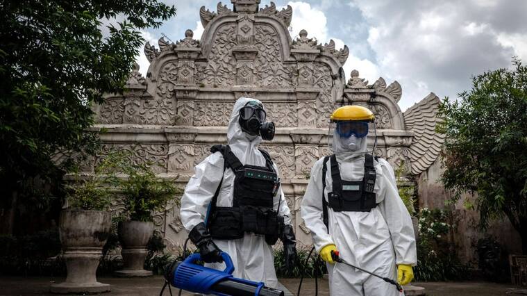 YOGYAKARTA, INDONESIA - MARCH 31: Disinfection volunteers stand as they spray disinfectant at the Taman Sari Water Castle complex, a popular tourist attraction, to prevent the spread of COVID-19 on March 31, 2020 in Yogyakarta, Indonesia. The Indonesia officials has so far confirmed 1.528 cases of the deadly coronavirus in the country with at least 136 recorded fatalities. According to the media and researchers reported the country already has the most deaths in south-east Asia, and estimated that there could be tens of thousands of hidden infections across the country. (Photo by Ulet Ifansasti/Getty Images)