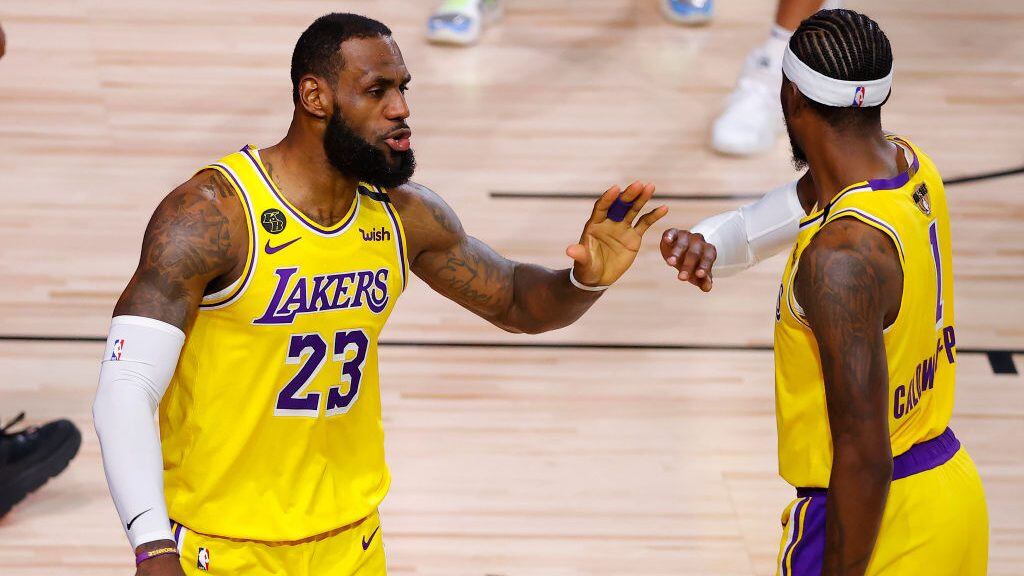LAKE BUENA VISTA, FLORIDA - OCTOBER 06: LeBron James #23 of the Los Angeles Lakers reacts with Kentavious Caldwell-Pope #1 of the Los Angeles Lakers after drawing a foul during the fourth quarter against the Miami Heat in Game Four of the 2020 NBA Finals at AdventHealth Arena at the ESPN Wide World Of Sports Complex on October 6, 2020 in Lake Buena Vista, Florida. NOTE TO USER: User expressly acknowledges and agrees that, by downloading and or using this photograph, User is consenting to the terms and conditions of the Getty Images License Agreement. (Photo by Kevin C. Cox/Getty Images)