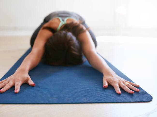 This is a photo of a woman doing the child's pose on a yoga mat. See PA Feature WELLBEING Easy. WARNING: This picture must only be used to accompany PA feature WELLBEING Easy. (Photo by Alamy/PA Images via Getty Images)