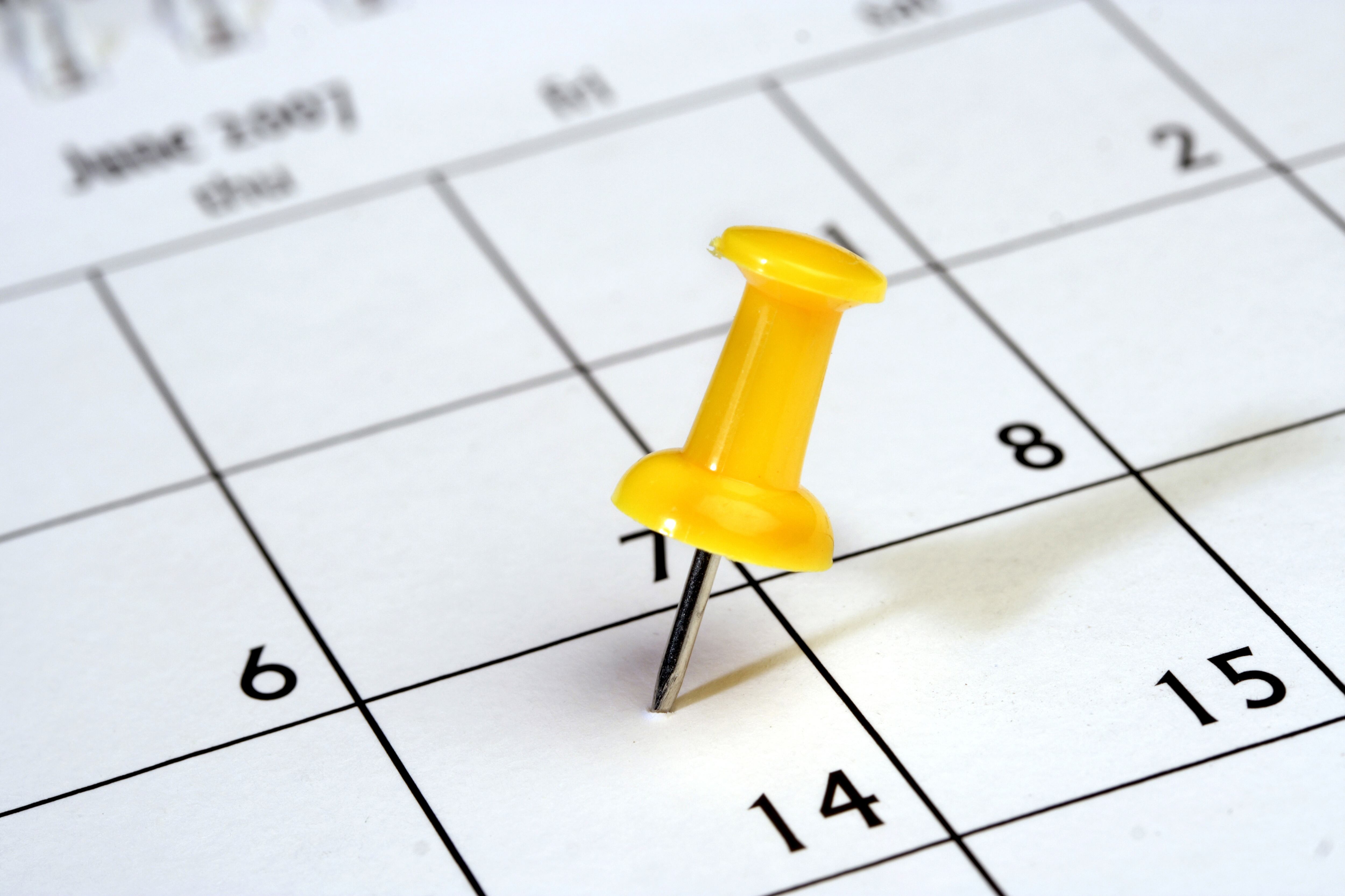 Push pin on calendar, close up