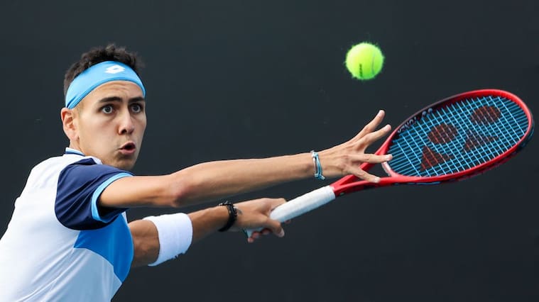 Chile's Alejandro Tabilo hits a return against John Isner of the US during their men's singles match on day four of the Australian Open tennis tournament in Melbourne on January 23, 2020. (Photo by DAVID GRAY / AFP) / IMAGE RESTRICTED TO EDITORIAL USE - STRICTLY NO COMMERCIAL USE (Photo by DAVID GRAY/AFP via Getty Images)