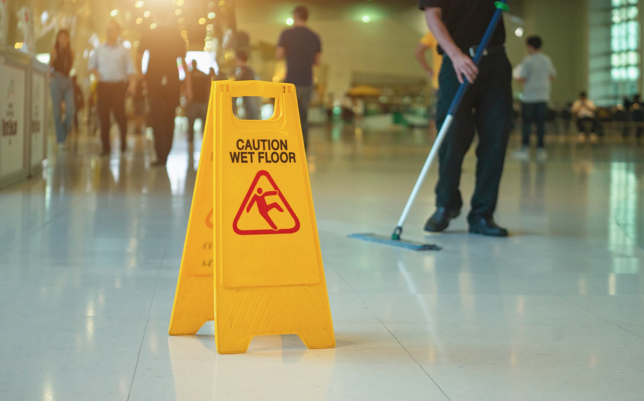 Yellow wet floor warning sign on the floor
