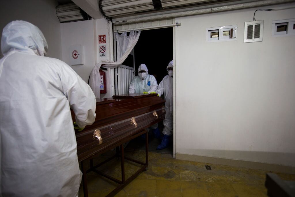 Trabajadores trasladan a una víctima del Covid-19 en México