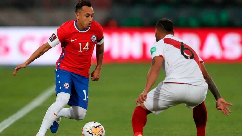 Chile's Fabian Orellana (L) is marked by Peru's Miguel Trauco during their closed-door 2022 FIFA World Cup South American qualifier football match at the National Stadium in Santiago, on November 13, 2020. (Photo by IVAN ALVARADO / POOL / AFP) (Photo by IVAN ALVARADO/POOL/AFP via Getty Images)