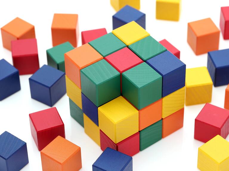 small wooden colorful square blocks puzzle on a white background