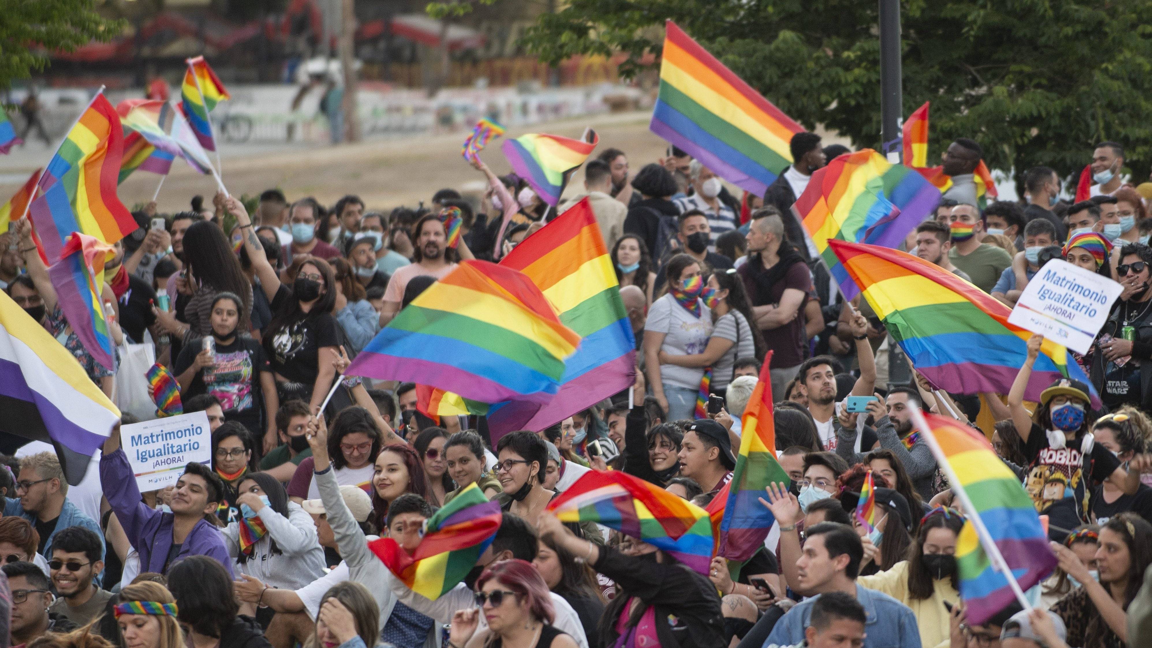 SANTIAGO, CHILE - DECEMBER 07: People celebrate waving rainbow flags during a rally after the bill for same-sex marriage was approved by the Chilean senate on December 7, 2021 in Santiago, Chile. Chile, which legalized same-sex civil unions in 2015, has been discussing gay marriage since 2017. (Photo by Claudio Santana/Getty Images)
