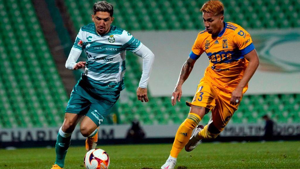 Diego Valdes (L) of Santos vies for the ball with Carlos Salcedo (R) of Tigres during the Mexican Clausura 2021 tournament at the TSM Corona stadium in Torreon, Coahuila state, Mexico on January 17, 2021. (Photo by TOMAS MALDONADO / AFP) (Photo by TOMAS MALDONADO/AFP via Getty Images)