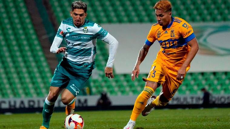 Diego Valdes (L) of Santos vies for the ball with Carlos Salcedo (R) of Tigres during the Mexican Clausura 2021 tournament at the TSM Corona stadium in Torreon, Coahuila state, Mexico on January 17, 2021. (Photo by TOMAS MALDONADO / AFP) (Photo by TOMAS MALDONADO/AFP via Getty Images)