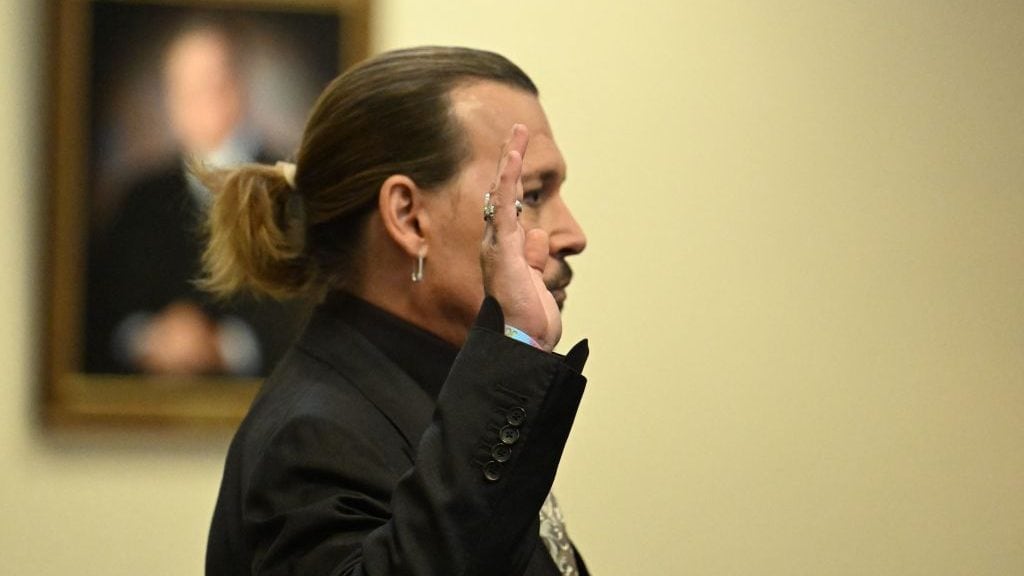 US actor Johnny Depp is sworn in during his defamation trial in the Fairfax County Circuit Courthouse in Fairfax, Virginia, on April 19, 2022. - Depp is suing ex-wife Amber Heard for libel after she wrote an op-ed piece in The Washington Post in 2018 referring to herself as a public figure representing domestic abuse. (Photo by JIM WATSON / POOL / AFP) (Photo by JIM WATSON/POOL/AFP via Getty Images)