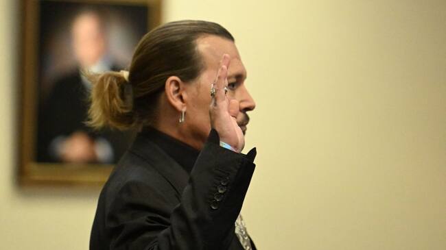 US actor Johnny Depp is sworn in during his defamation trial in the Fairfax County Circuit Courthouse in Fairfax, Virginia, on April 19, 2022. - Depp is suing ex-wife Amber Heard for libel after she wrote an op-ed piece in The Washington Post in 2018 referring to herself as a public figure representing domestic abuse. (Photo by JIM WATSON / POOL / AFP) (Photo by JIM WATSON/POOL/AFP via Getty Images)