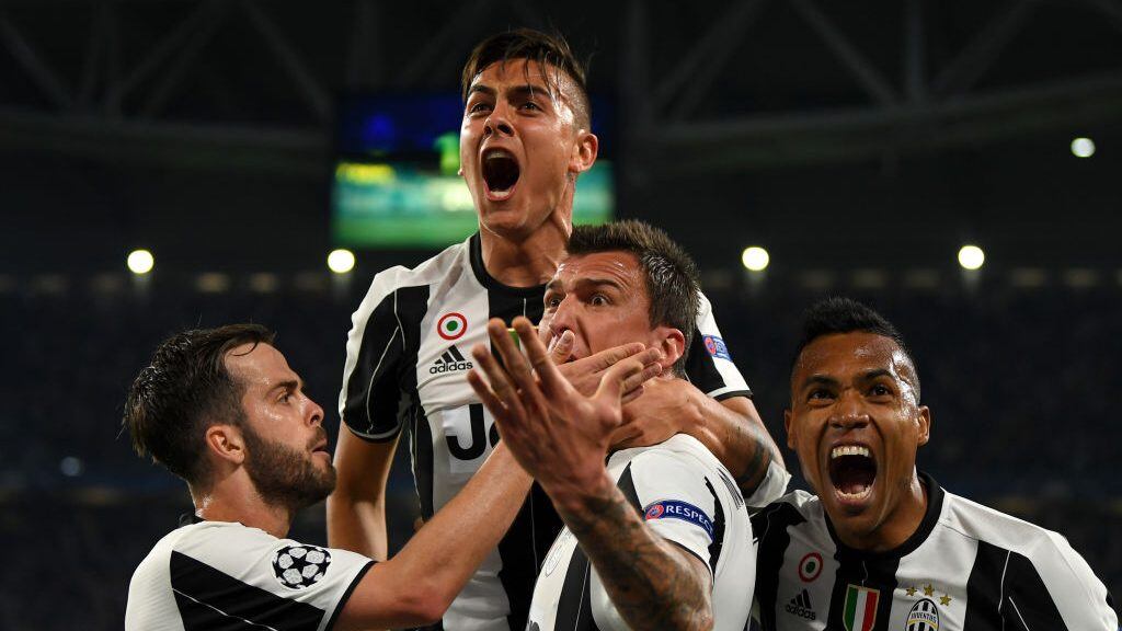 TURIN, ITALY - APRIL 11:  Paulo Dybala of Juventus celebrates with Miralem Pjanic, Mario Mandzukic and Alex Sandro of Juventus after scoring his team's second goal during the UEFA Champions League Quarter Final first leg match between Juventus and FC Barcelona at Juventus Stadium on April 11, 2017 in Turin, Italy.  (Photo by Mike Hewitt/Getty Images)