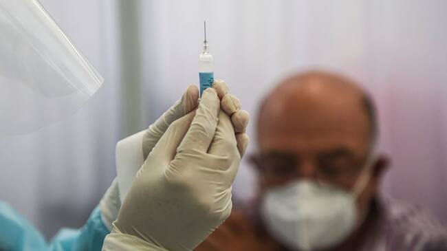 A health worker prepares a syringe to inoculate a volunteer with a COVID-19 vaccine produced by the Chinese Sinopharm during its trial at the Clinical Studies Center of the Cayetano Heredia University in Lima on December 09, 2020. (Photo by ERNESTO BENAVIDES / AFP) (Photo by ERNESTO BENAVIDES/AFP via Getty Images)