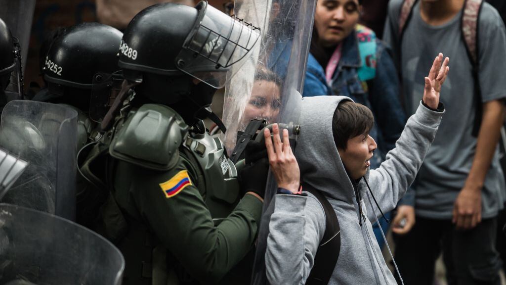 Un efectivo policial reprime una protesta estudiantil en la ciudad de Bogotá