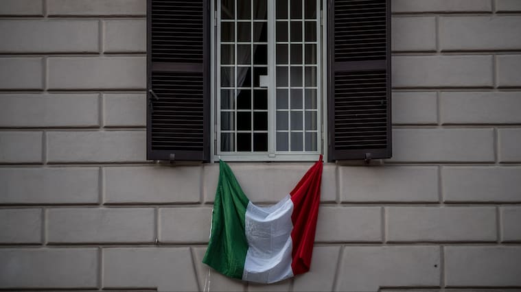 ROME, ITALY - MARCH 22: The Italian national flag hangs from a balcony during the Coronavirus emergency, on March 22, 2020 in Rome, Italy. The Italian government continues to enforce the nationwide lockdown measures to control the spread of COVID-19. (Photo by Antonio Masiello/Getty Images)