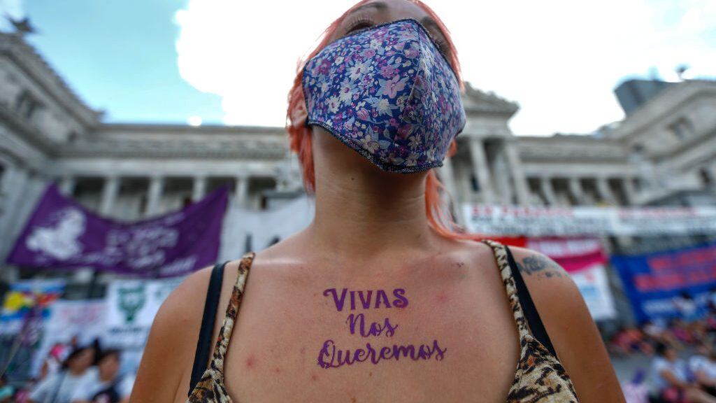 BUENOS AIRES, ARGENTINA - MARCH 08: A woman shows her chest with the words "We want us (women) alive" painted on it as she takes part in a demonstration to mark the International Women's Day outside the Congress on March 8, 2021 in Buenos Aires, Argentina. This year the main demand is to stop the femicides and transvesticides, after 50 have been officially registered in the first two months of 2021. (Photo by Marcos Brindicci/Getty Images)