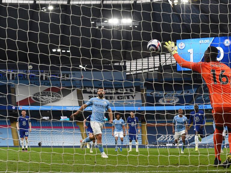 MANCHESTER, ENGLAND - MAY 08: Edouard Mendy of Chelsea saves a penalty taken by Sergio Aguero of Manchester City during the Premier League match between Manchester City and Chelsea at Etihad Stadium on May 08, 2021 in Manchester, England. Sporting stadiums around the UK remain under strict restrictions due to the Coronavirus Pandemic as Government social distancing laws prohibit fans inside venues resulting in games being played behind closed doors. (Photo by Shaun Botterill/Getty Images)