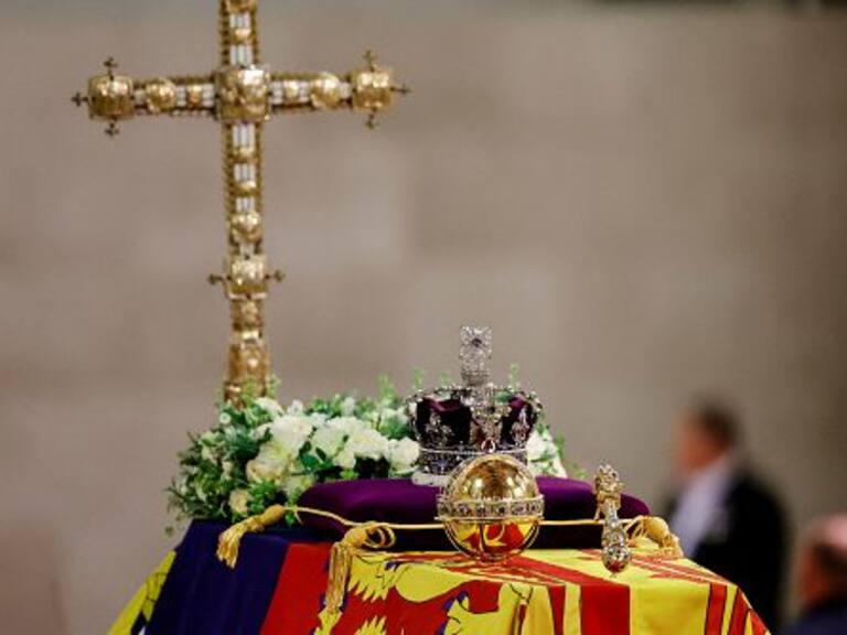 LONDON, ENGLAND - SEPTEMBER 18: A view of Queen Elizabeth&#039;s coffin, draped in the Royal Standard, with the Imperial State Crown and flowers on top, following her death, during her lying-in-state at Westminster Hall on September 18, 2022 in London, England. Members of the public are able to pay respects to Her Majesty Queen Elizabeth II for 23 hours a day from 17:00 on September 18, 2022 until 06:30 on September 19, 2022.  Queen Elizabeth II died at Balmoral Castle in Scotland on September 8, 2022, and is succeeded by her eldest son, King Charles III. (Photo by Sarah Meyssonnier-WPA Pool/Getty Images)