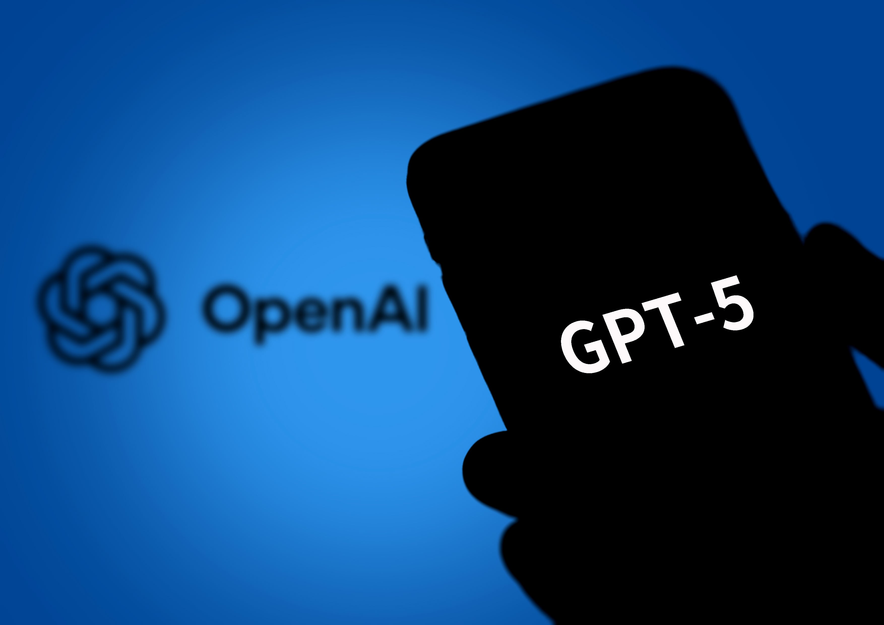 BEIJING, CHINA - AUGUST 08: In this photo illustration, the logo of GPT-5 is displayed on a smartphone screen with an Open AI logo in the background on August 8, 2025 in Beijing, China. OpenAI on August 7 announced GPT-5, its latest and most advanced AI model. (Photo by VCG/VCG via Getty Images)