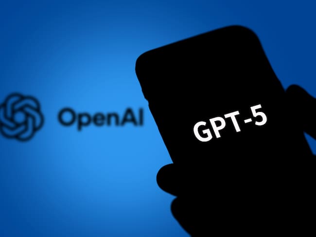 BEIJING, CHINA - AUGUST 08: In this photo illustration, the logo of GPT-5 is displayed on a smartphone screen with an Open AI logo in the background on August 8, 2025 in Beijing, China. OpenAI on August 7 announced GPT-5, its latest and most advanced AI model. (Photo by VCG/VCG via Getty Images)