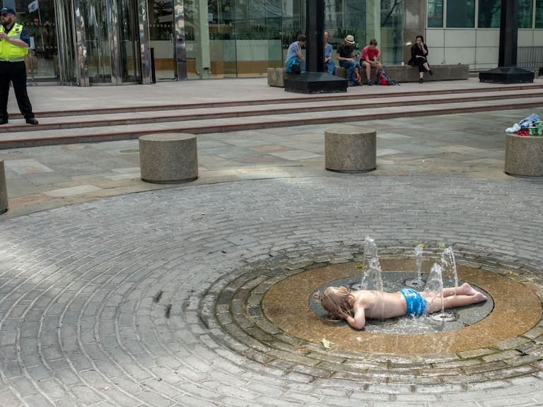 Un niño busca bajar el calor en un juego de agua en la ciudad de Londres