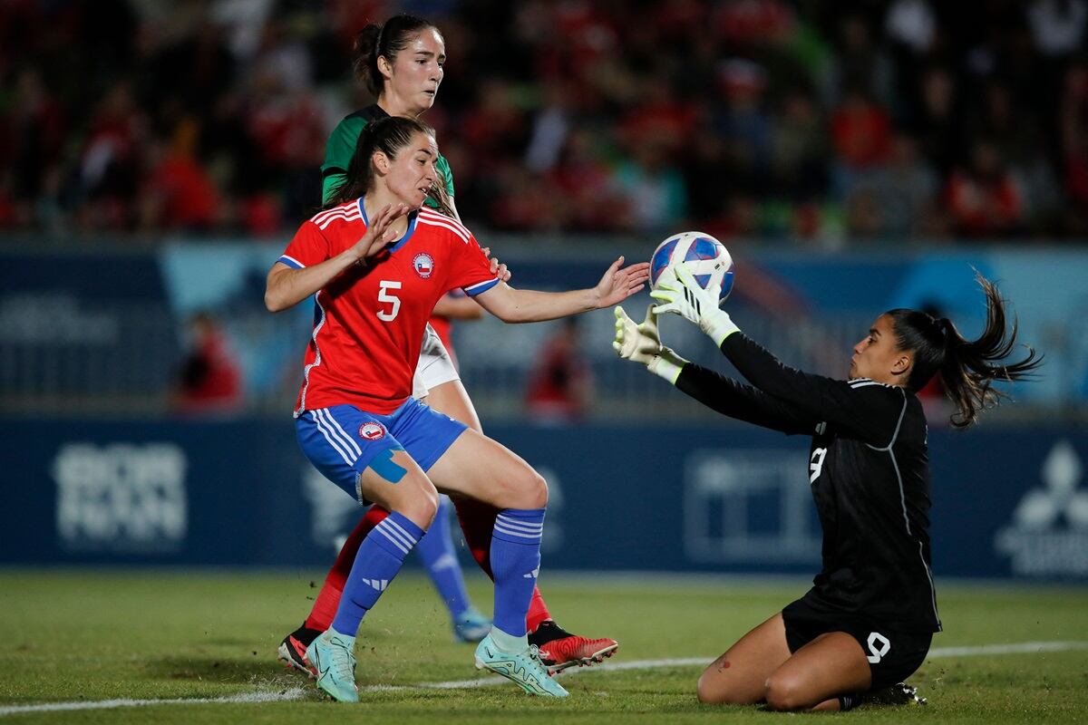 Chile's goalkeeper Maria Jose Urrutia (R) and defender Fernanda Ramirez (L) fight for the ball with Mexico's defender Diana Ordoñez during the women's team gold medal football match between Mexico and Chile at the Pan American Games Santiago 2023, in the Elias Figueroa stadium, in Valparaiso, Chile, on November 3, 2023. (Photo by Javier TORRES / AFP) (Photo by JAVIER TORRES/AFP via Getty Images)