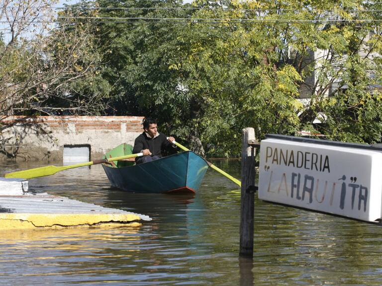 A man rows in a street of a flooded neighborhood of Durazno city, some 200 km north of Montevideo, 09 May, 2007. About 12,000 people were evacuated from their houses in the most important flood in Uruguay in the last 50 years. AFP PHOTO/Miguel ROJO (Photo by MIGUEL ROJO / AFP) (Photo by MIGUEL ROJO/AFP via Getty Images)
