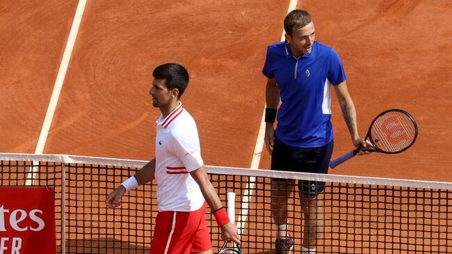 Serbia's Novak Djokovic (L) and Britain's Daniel Evans leave the court after their third round singles match on day six of the Monte-Carlo ATP Masters Series tournament in Monaco on April 15, 2021. (Photo by Valery HACHE / AFP) (Photo by VALERY HACHE/AFP via Getty Images)