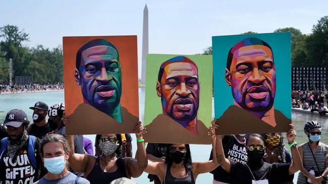 WASHINGTON, DC - AUGUST 28: Attendees hold images of George Floyd as they participate in the March on Washington at the Lincoln Memorial August 28, 2020 in Washington, DC. Today marks the 57th anniversary of Rev. Martin Luther King Jr.'s "I Have A Dream" speech at the same location. (Photo by Drew Angerer/Getty Images)