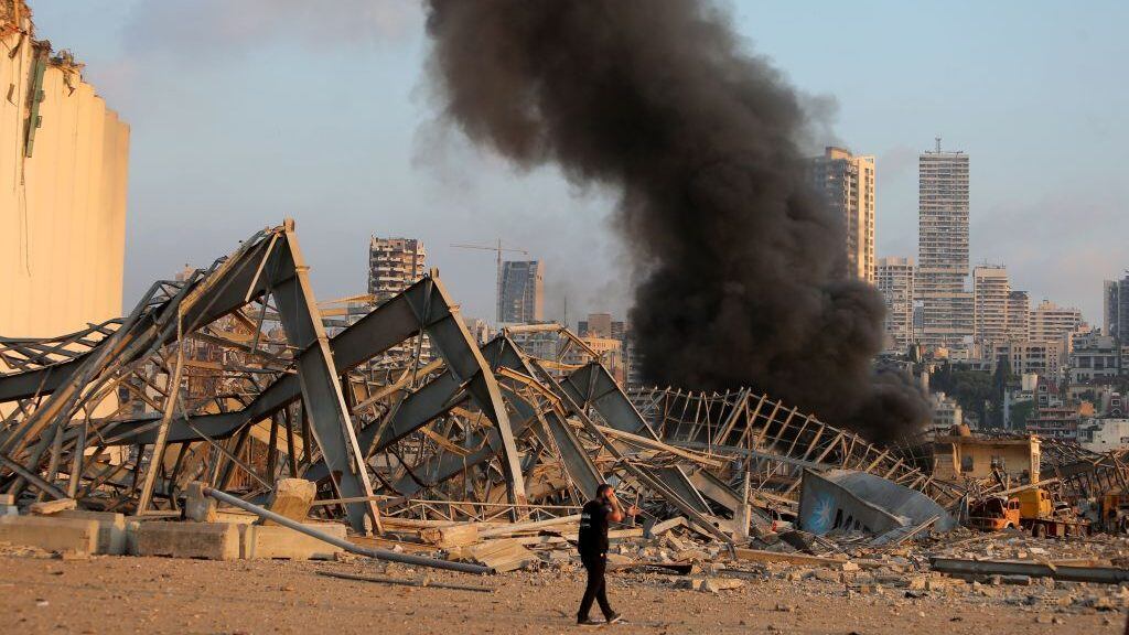 TOPSHOT - EDITORS NOTE: Graphic content / A picture shows the scene of an explosion near the port in the Lebanese capital Beirut on August 4, 2020. - Two huge explosion rocked the Lebanese capital Beirut, wounding dozens of people, shaking buildings and sending huge plumes of smoke billowing into the sky. Lebanese media carried images of people trapped under rubble, some bloodied, after the massive explosions, the cause of which was not immediately known. (Photo by STR / AFP) (Photo by STR/AFP via Getty Images)