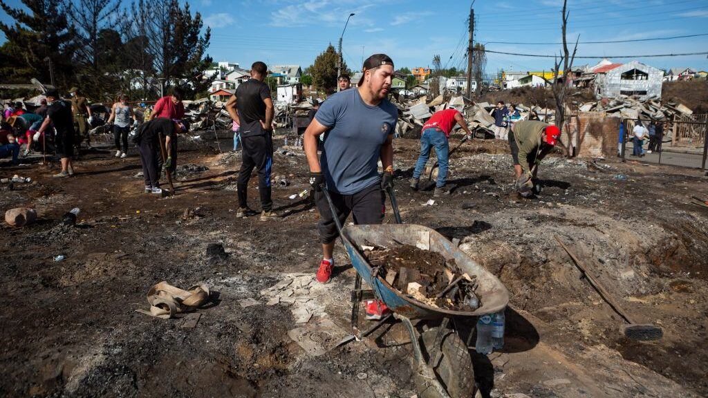 10 DE DICIEMBRE 2021 / CASTROUn hombre utiliza una carretilla par la remoción de escombros tras incendio forestal que destruyo más de 140 casas en la población Camilo Henrriquez y Villa los Presidentes, durante mega incendio en la ciudad de Castro, Chiloé.
FOTO: FELIPE CONSTANZO / AGENCIAUNO